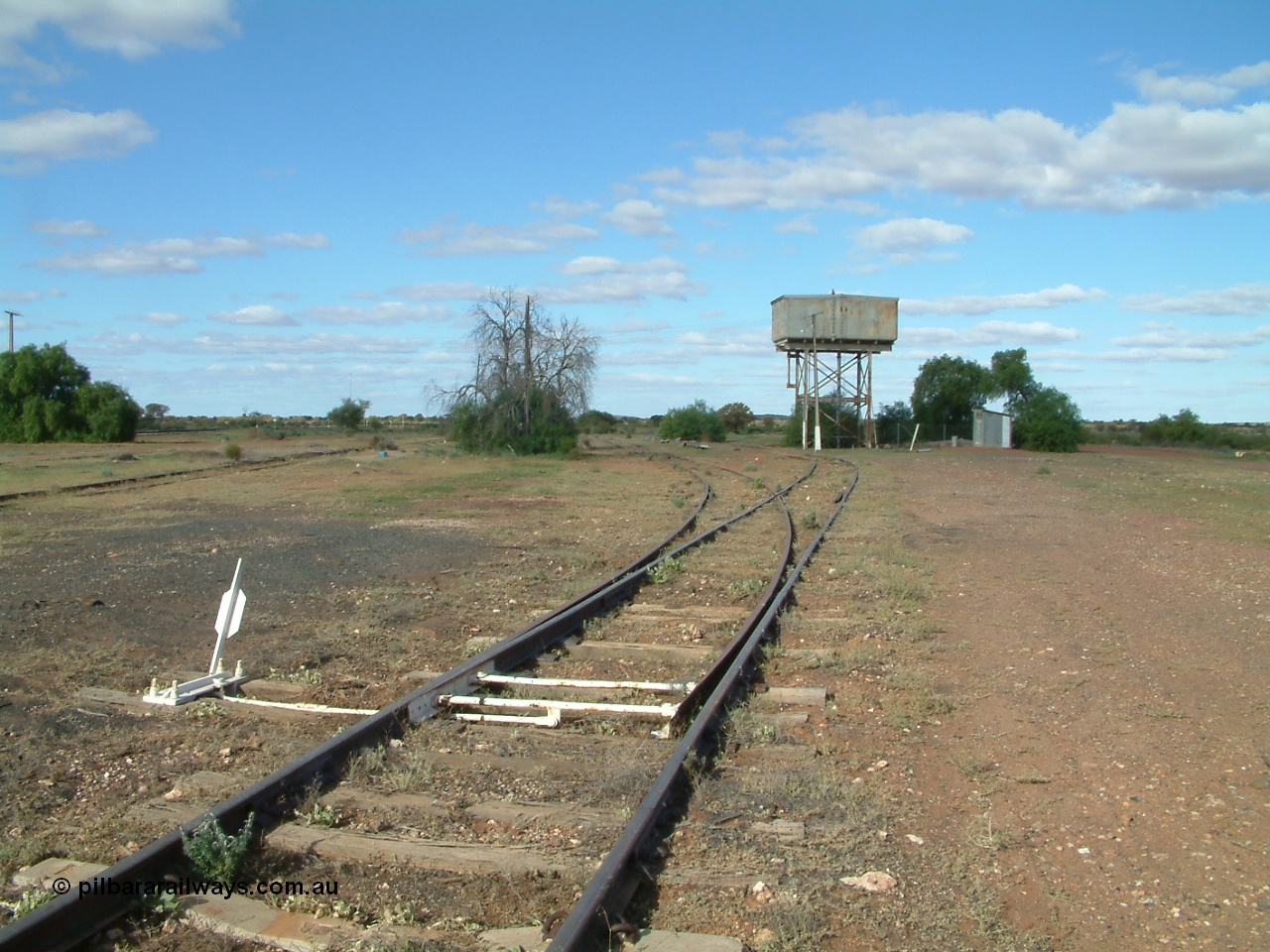 030415 154820
Tarcoola, at the 504.5 km, looking south east along the No. 1 Water Road, set of points is the No. 2 Loco Road, No. 1 Loco and Camp Train roads are visible to the left. Water tank on stand. [url=https://goo.gl/maps/AhdgsdPfRS8cXWMP8]GeoData location[/url]. 15th April 2003.
