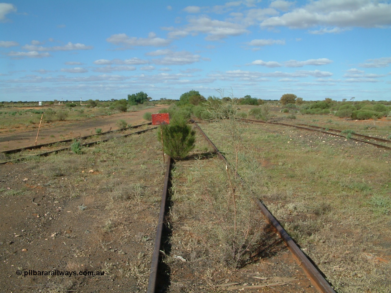 030415 155126
Tarcoola, at the 504.5 km, looking east, end of the No. 2 Loco Road, No. 1 Water Road curving in from the right, spur from Camp Train and No. 1 Loco Roads as left and mainline to the far left. [url=https://goo.gl/maps/PdmQ6oubAatDdHrL7]GeoData location[/url]. 15th April 2003.
