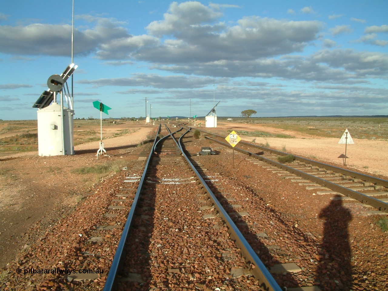 030415 171358
Tarcoola, at the 504.5 km, looking east along the Central Australia line at the western end of the loop and Trans Australian is the right road. Tarcoola is the junction for the TAR and CAR railways situated 504 km from the 0 km datum at Coonamia. 15th April 2003.
