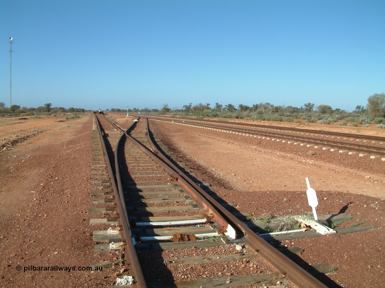 030416 083850
Carnes Siding located at the 566.4 km on the Central Australian line from Tarcoola to Alice Springs. Looking south from the goods siding off the loop with deadend siding to loading ramp, communications tower at left. [url=https://goo.gl/maps/SFbQb2qfyMiVfcXq7]GeoData location[/url]. 16th April 2003.
