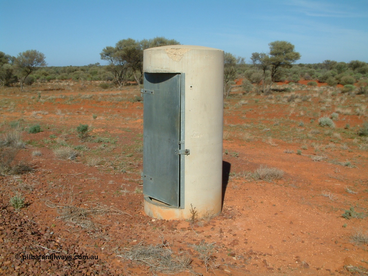 030416 094500
Wirrida Siding, train control phone booth 'pillbox'. Located at the 641 km from the 0 datum at Coonamia and 137 km north of Tarcoola between Carnes and Manguri on the Tarcoola - Alice Springs line. [url=https://goo.gl/maps/eznFBHok5p6yPEcq6]GeoData location[/url]. 16th April 2003.
