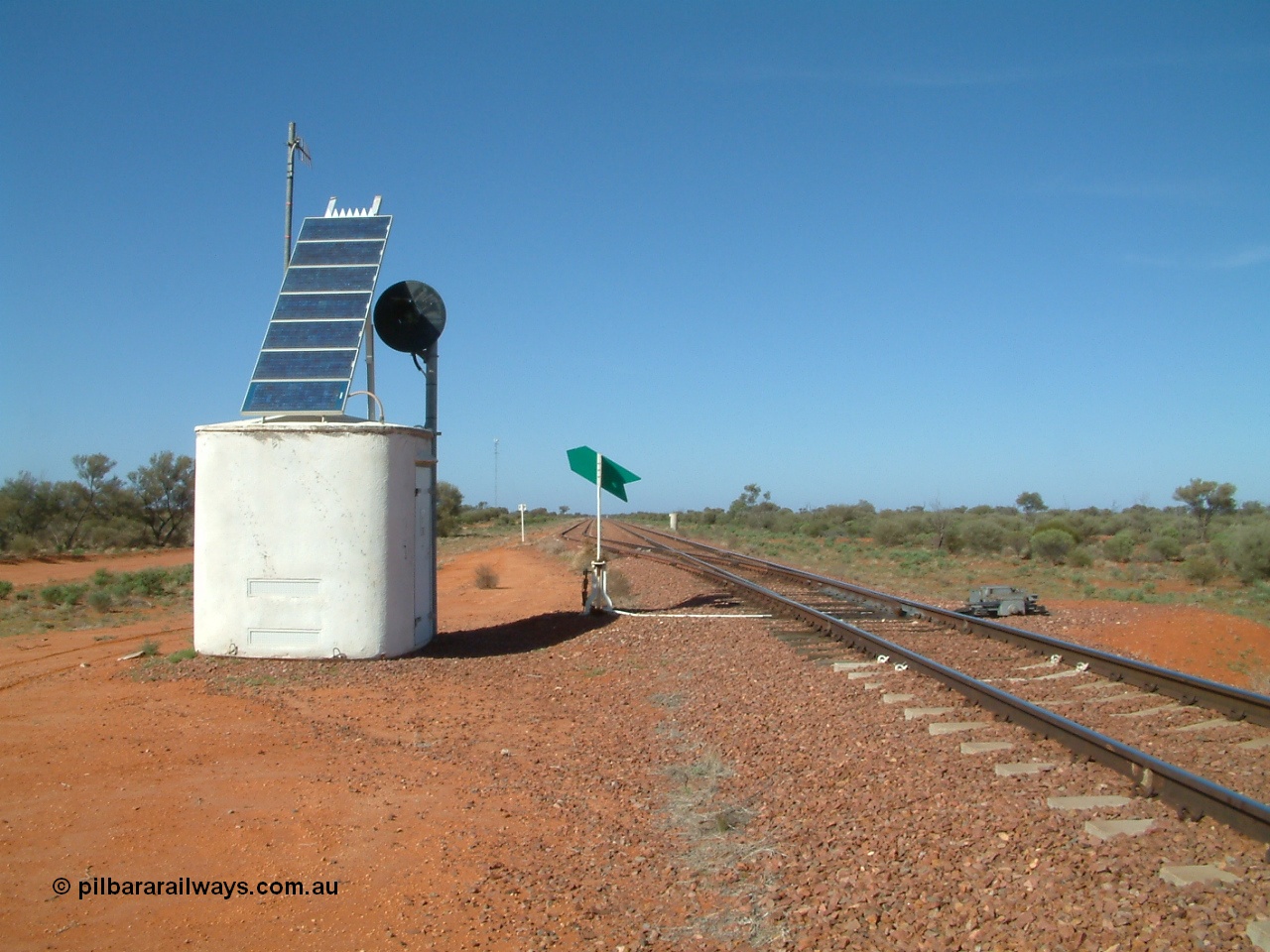 030416 095502
Wirrida Siding, looking south towards Tarcoola from the north end of the loop, concrete interlocking hut with searchlight repeater signal, point indicator, communications tower in the distance on the left and train control 'pillbox' on the right. Located at the 641 km from the 0 datum at Coonamia and 137 km north of Tarcoola between Carnes and Manguri on the Tarcoola - Alice Springs line. [url=https://goo.gl/maps/corZKNsBFkCGAnkR8]GeoData location[/url]. 16th April 2003.
