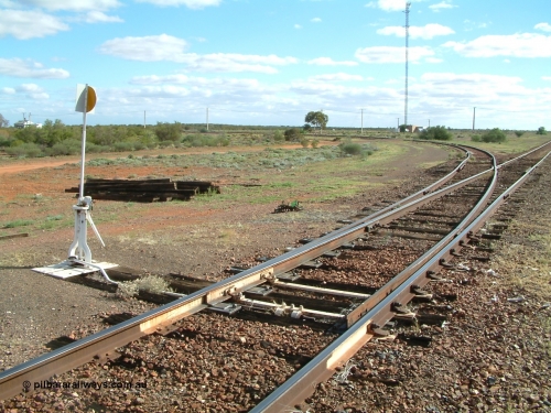 030415 154518
Tarcoola, at the 504.5 km, looking west along the eastern leg of the triangle, power station on the left, loop line running to the right. Tarcoola is the junction for the TAR and CAR railways situated 504 km from the 0 km datum at Coonamia. [url=https://goo.gl/maps/NmBNmrosE7e6d5gx8]GeoData location[/url]. 15th April 2003.
