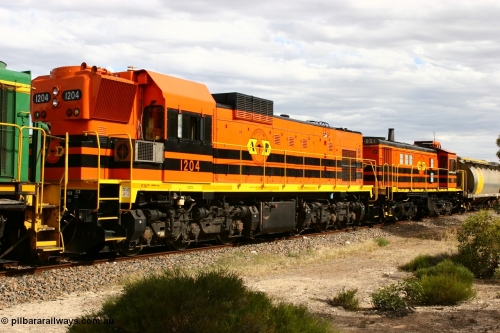 060108 2064
Lock, ARG 1200 class unit 1204, a Clyde Engineering EMD model G12C serial 65-428, final of fourteen originally built between 1960-65 for WAGR as their A class A 1514, fitted with dynamic brakes and financed by Western Mining Corporation, started on the Eyre Peninsula in August 2004.
Keywords: 1200-class;1204;Clyde-Engineering-Granville-NSW;EMD;G12C;65-428;A-class;A1514;