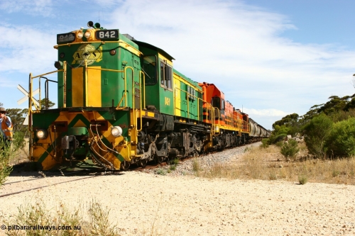 060109 2102
Kyancutta, Kyancutta Tanks Rd grade crossing, ASR 830 class unit 842, an AE Goodwin built ALCo DL531 model loco serial 84140 leads EMD unit 1204 due to air-conditioning trouble and sister ALCo 851 as the empty north bound grain train pauses for a crew change. 9th January 2006.
Keywords: 830-class;842;AE-Goodwin;ALCo;DL531;84140;
