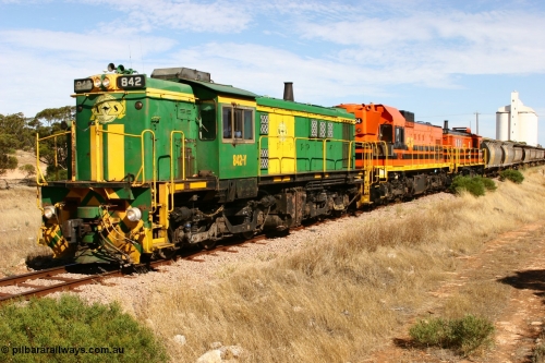 060109 2115
Kyancutta, ASR 830 class unit 842, an AE Goodwin built ALCo DL531 model loco serial 84140 leads EMD unit 1204 due to air-conditioning trouble and sister ALCo 851 as they shunt across Museum Terrace to place empty grain waggons on the silo loop. 9th January 2006.
Keywords: 830-class;842;AE-Goodwin;ALCo;DL531;84140;