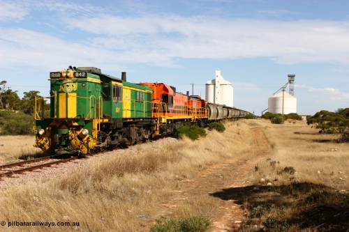 060109 2117
Kyancutta, ASR 830 class unit 842, an AE Goodwin built ALCo DL531 model loco serial 84140 leads EMD unit 1204 due to air-conditioning trouble and sister ALCo 851 as they shunt across Museum Terrace to place empty grain waggons on the silo loop. 9th January 2006.
Keywords: 830-class;842;AE-Goodwin;ALCo;DL531;84140;