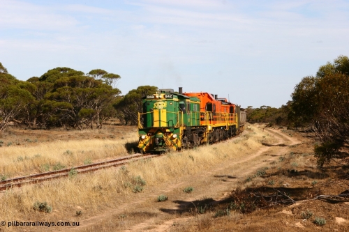 060109 2138
Wannamana, [url=https://goo.gl/maps/43EOs]on the curve[/url] 2 km north of the former station site empty train lead by ASR 830 class unit 842, an AE Goodwin built ALCo DL531 model loco serial 84140 with an EMD 1200 class and a sister ALCo unit. 9th January 2006.
Keywords: 830-class;842;AE-Goodwin;ALCo;DL531;84140;
