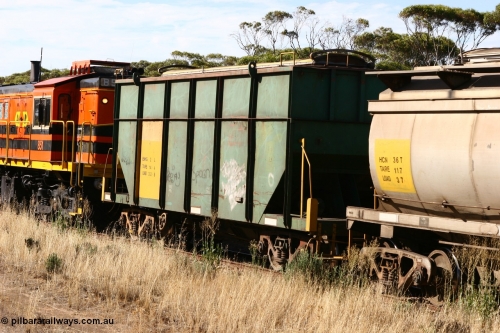 060109 2146
Wannamana, trailing view of former Australian National narrow gauge ENHG type bogie grain waggon ENHG 2, originally built by Moore Road Ind, Victoria as NB type NB 1395 ballast hopper for the NAR, then to standard gauge in 1975 as BA type BA 1539, recoded to AHTY in 1980, to EP April 1984, recoded to NHG type NHG 5 in May 1984, then again to ENHT type ENHT 5 in March 1985 and further rebuilt forming one half of ENHG type grain waggon in August 1986. The conversion involved splicing two AHTY-ENHT type waggons together at Port Lincoln workshops, part of an empty train [url=https://goo.gl/maps/43EOs]on the curve[/url]. 9th January 2006.
Keywords: ENHG-type;ENHG2;Moore-Road-Ind-Victoria;NB-type;NB1395;BA-type;BA1539;AHTY-type;NHG-type;NHG5;ENHT-type;