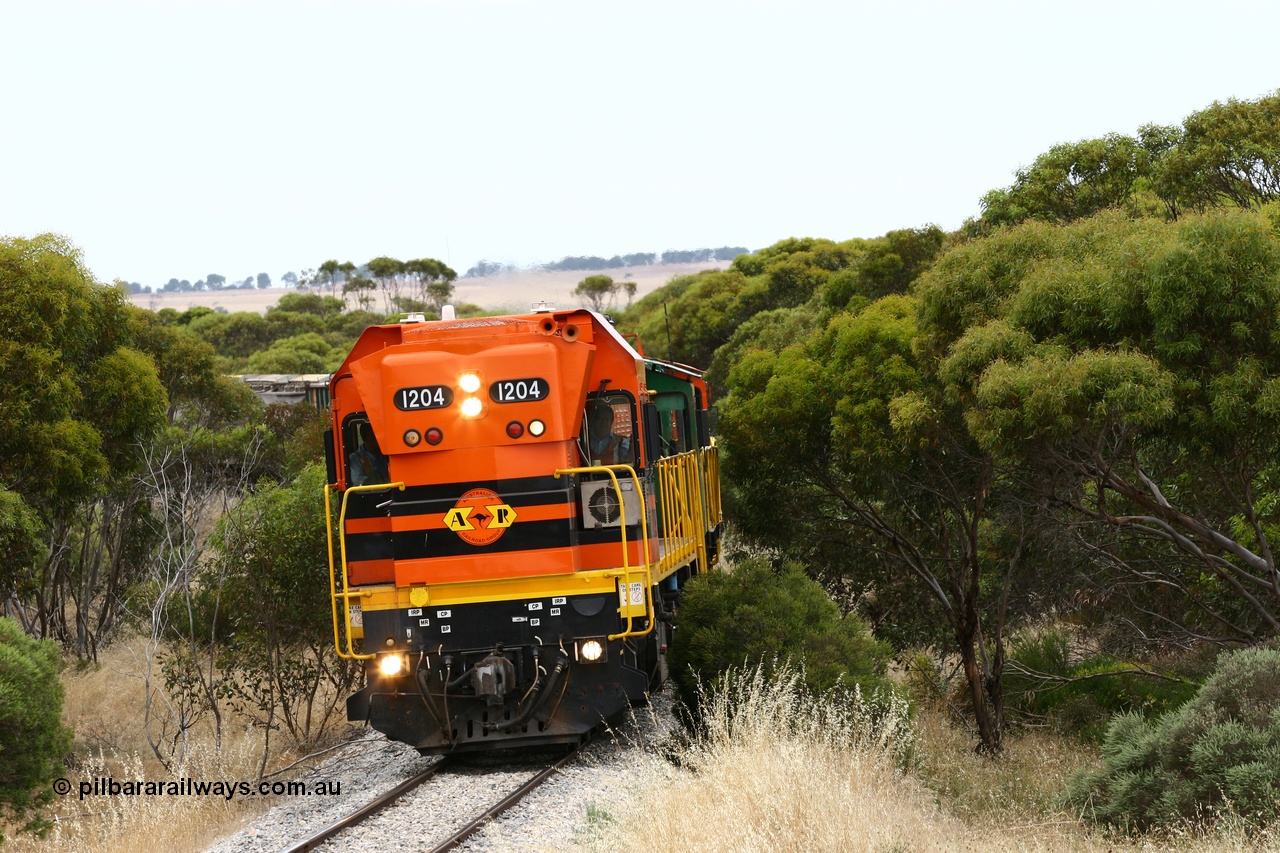 060110 2210
On the curve near the 85 km between Yeelanna and Karkoo, ARG 1200 class unit 1204, a Clyde Engineering EMD model G12C serial 65-428, originally built for the WAGR as the final unit of fourteen A class locomotives in 1965 and sent to the Eyre Peninsula in July 2004 leads an empty grain train. [url=https://goo.gl/maps/7kwfXBE6nS12]Approx. location of image[/url].
Keywords: 1200-class;1204;Clyde-Engineering-Granville-NSW;EMD;G12C;65-428;A-class;A1514;