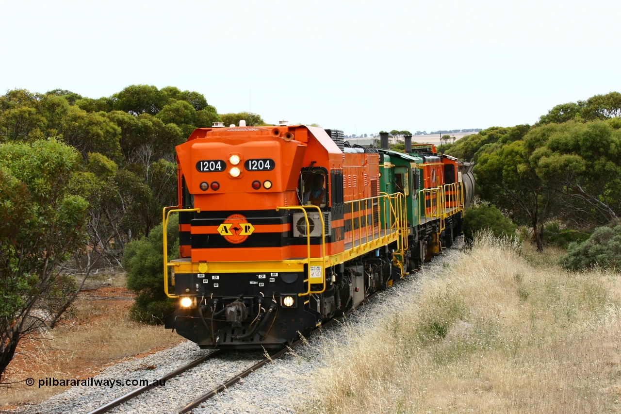 060110 2213
On the curve near the 85 km between Yeelanna and Karkoo, ARG 1200 class unit 1204, a Clyde Engineering EMD model G12C serial 65-428, originally built for the WAGR as the final unit of fourteen A class locomotives in 1965 and sent to the Eyre Peninsula in July 2004 leads an empty grain train. [url=https://goo.gl/maps/7kwfXBE6nS12]Approx. location of image[/url].
Keywords: 1200-class;1204;Clyde-Engineering-Granville-NSW;EMD;G12C;65-428;A-class;A1514;