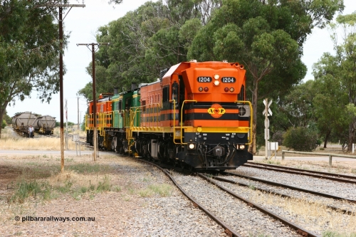 060110 2163
Cummins, view across Railway Terrace of empty grain train shunting the Cummins Bunker track to pick up empty hoppers, behind ARG 1200 class unit 1204, a Clyde Engineering EMD model G12C serial 65-428, originally built for the WAGR as the final unit of fourteen A class locomotives in 1965 and sent to the Eyre Peninsula in July 2004 and two 830 class AE Goodwin built ALCo model DL531 units 842 serial 84140 ex SAR broad gauge to Eyre Peninsula in October 1987, and 851 serial 84137 new to Eyre Peninsula in 1962. [url=https://goo.gl/maps/q5aVqSmjCP62]Approx. location of image[/url].
Keywords: 1200-class;1204;Clyde-Engineering-Granville-NSW;EMD;G12C;65-428;A-class;A1514;830-class;842;851;AE-Goodwin;ALCo;DL531;84137;84140;