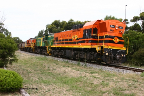 060110 2173
Cummins, empty grain train departing yard on the Penong mainline behind ARG 1200 class unit 1204, a Clyde Engineering EMD model G12C serial 65-428, originally built for the WAGR as the final unit of fourteen A class locomotives in 1965 and sent to the Eyre Peninsula in July 2004 and two 830 class AE Goodwin built ALCo model DL531 units 842 serial 84140 ex SAR broad gauge to Eyre Peninsula in October 1987, and 851 serial 84137 new to Eyre Peninsula in 1962. [url=https://goo.gl/maps/cL7ZN9y12t92]Approx. location of image[/url].
Keywords: 1200-class;1204;Clyde-Engineering-Granville-NSW;EMD;G12C;65-428;A-class;A1514;830-class;842;851;AE-Goodwin;ALCo;DL531;84137;84140;