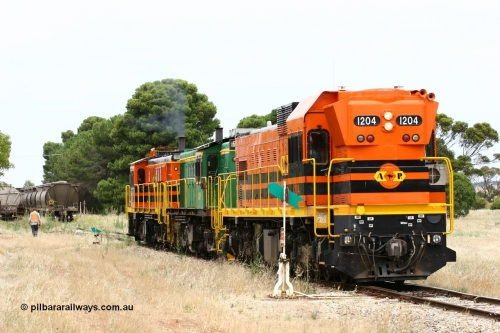 060110 2206
Yeelanna, ARG 1200 class unit 1204, a Clyde Engineering EMD model G12C serial 65-428, originally built for the WAGR as the final unit of fourteen A class locomotives in 1965 and sent to the Eyre Peninsula in July 2004 shunts back onto its train of empties on the mainline as the second person prepares to re-join the train, a rake of waggons in grain siding await loading. [url=https://goo.gl/maps/1JetzWBTGAw]Approx. location of image[/url].
Keywords: 1200-class;1204;Clyde-Engineering-Granville-NSW;EMD;G12C;65-428;A-class;A1514;830-class;842;851;AE-Goodwin;ALCo;DL531;84137;84140;