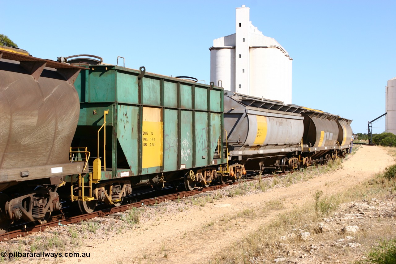 060111 2354
Kyancutta, this shot shows three of the types of waggon used, former Australian National narrow gauge ENHG type bogie grain waggon ENHG 3, originally built by Moore Road Ind, Victoria as NB type NB 1398 ballast hopper for the NAR, then to standard gauge in 1975 as BA type BA 1540, recoded to AHTY in 1980, to EP April 1984, recoded to NHG type NHG 6 in May 1984, then again to ENHT type ENHT 6 in March 1985 and further rebuilt forming one half of ENHG type grain waggon in August 1986. The conversion involved splicing two AHTY-ENHT type waggons together at Port Lincoln workshops, an HCN type HCN 4 was modified at Islington Workshops in 1978-80 and started life as a Tulloch built NHB type iron ore hopper for the CR on the North Australia Railway in 1968-69, and an SAR built HAN type as they are shunted back into the grain siding for loading. 11th January 2006.
Keywords: ENHG-type;ENHG3;Moore-Road-Ind-Victoria;NB-type;NB1398;BA-type;BA1540;AHTY-type;NHG-type;NHG6;ENHT-type;