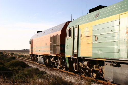 060113 2423
Ceduna, loaded gypsum train 6DD2 stirs up the dust behind the triple Clyde Engineering EMD JL22C model 1600 / NJ class combination of 1604 serial 71-731 and originally NJ 4, NJ 3 serial 71-730 and 1601 serial 71-728 class leader NJ 1, all three units started on the Central Australia Railway in 1971 and were transferred to the Eyre Peninsula in 1981. 08:10 AM on the Friday the 13th January 2006.
Keywords: 1600-class;1604;Clyde-Engineering-Granville-NSW;EMD;JL22C;71-731;NJ-class;NJ4;