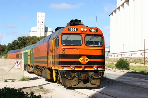 060113 2442
Thevenard, at the Gypsum Resources Australian (GRA) gypsum unloading site, 1604 leads a triple consist of Clyde Engineering EMD JL22C model 1600 / NJ class combination of 1604 serial 71-731 and originally NJ 4, NJ 3 serial 71-730 and 1601 serial 71-728 class leader NJ 1, all three units started on the Central Australia Railway in 1971 and were transferred to the Eyre Peninsula in 1981. 1604 and 1601 both renumbered in 2004. Friday 13th January 2006.
Keywords: 1600-class;1604;Clyde-Engineering-Granville-NSW;EMD;JL22C;71-731;NJ-class;NJ4;