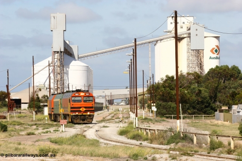 060113 2461
Thevenard, narrow gauge loco 1604 with a fresh crew depart the yard with empty train 6DD3, 1604 leads a triple consist of Clyde Engineering built EMD JL22C model 1600 / NJ class combination of 1604 serial 71-731 and originally NJ 4, NJ 3 serial 71-730 and 1601 serial 71-728 the original class leader NJ 1, all three units started on the Central Australia Railway in 1971 and were transferred to the Eyre Peninsula in 1981. 1604 and 1601 both renumbered in 2004. A roll-by is also being conducted by an outgoing crew member. 13th January 2006.
Keywords: 1600-class;1604;Clyde-Engineering-Granville-NSW;EMD;JL22C;71-731;NJ-class;NJ4;