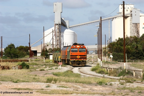 060113 2464
Thevenard, narrow gauge loco 1604 with a fresh crew depart the yard with empty train 6DD3, 1604 leads a triple consist of Clyde Engineering built EMD JL22C model 1600 / NJ class combination of 1604 serial 71-731 and originally NJ 4, NJ 3 serial 71-730 and 1601 serial 71-728 the original class leader NJ 1, all three units started on the Central Australia Railway in 1971 and were transferred to the Eyre Peninsula in 1981. 1604 and 1601 both renumbered in 2004. 13th January 2006.
Keywords: 1600-class;1604;Clyde-Engineering-Granville-NSW;EMD;JL22C;71-731;NJ-class;NJ4;