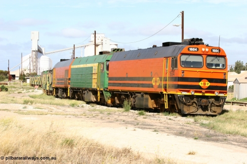 060113 2473
Thevenard, narrow gauge loco 1604 departs the yard with empty train 6DD3, 1604 leads a triple consist of Clyde Engineering built EMD JL22C model 1600 / NJ class combination of 1604 serial 71-731 and originally NJ 4, NJ 3 serial 71-730 and 1601 serial 71-728 the original class leader NJ 1, all three units started on the Central Australia Railway in 1971 and were transferred to the Eyre Peninsula in 1981. 1604 and 1601 both renumbered in 2004. 13th January 2006.
Keywords: 1600-class;1604;Clyde-Engineering-Granville-NSW;EMD;JL22C;71-731;NJ-class;NJ4;