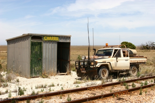 060113 2556
Charra at the 466.2 km, [url=https://goo.gl/maps/GpLTsHYeUymGtK5f7]Mallee style shelter building[/url]. Opened with the line on 13th February 1966 as a goods siding, reclassified as passing siding and extended, new goods loop siding constructed May 1982. 13th January 2006.
