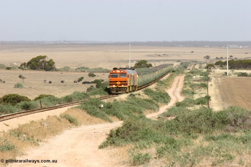060113 2574
Ceduna, or Denial Bay area, empty gypsum train 6DD5 blasts up hill at the 440 km, crossing Carpenter Corner Rd with power from triple 1600/NJ class units 1604, NJ 3 and 1601. 1604 in Australian Railroad Group livery is a Clyde Engineering built EMD JL22C model serial 71-731, originally built as NJ class NJ 4. [url=https://goo.gl/maps/ULA2PjjKh6nhwHTdA]Location approximation[/url]. 13th January 2006.
Keywords: 1600-class;1604;Clyde-Engineering-Granville-NSW;EMD;JL22C;71-731;NJ-class;NJ4;
