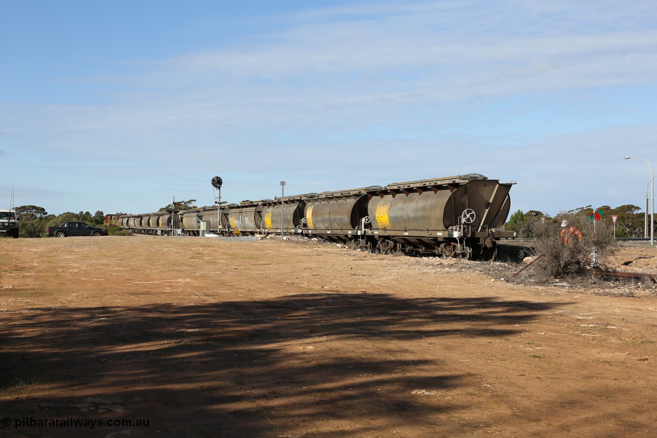 130704 0407
Kyancutta, south bound loaded grain train has stopped here to collect a loaded rack of grain waggons, the second driver has just restored the points for the mainline as the train waits across the Eyre Highway grade crossing and one of only three electric signals on the network, behind EMD 1204 and twin ALCo 830 units 873 and 851. 4th July 2013.
