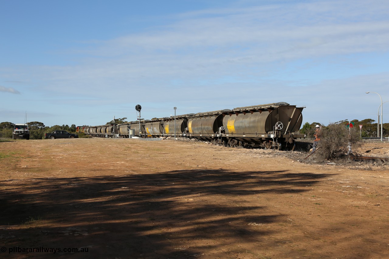 130704 0408
Kyancutta, south bound loaded grain train has stopped here to collect a loaded rack of grain waggons, the second driver has just restored the points for the mainline as the train waits across the Eyre Highway grade crossing and one of only three electric signals on the network, behind EMD 1204 and twin ALCo 830 units 873 and 851. 4th July 2013.
