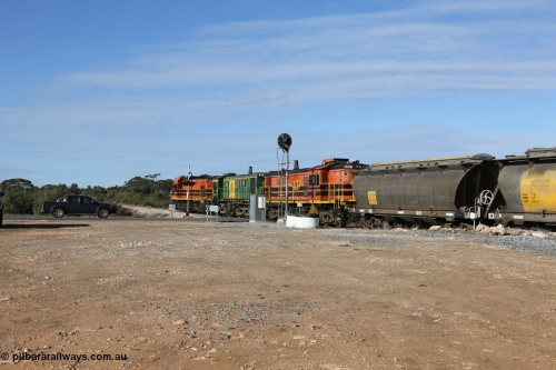 130704 0414
Kyancutta, south bound loaded grain train has stopped here to collect a loaded rack of grain waggons, seen here backing up to re-join the rest of the train on the mainline as it crosses the Eyre Highway grade crossing and one of only three electric signals on the network, behind EMD 1204 and twin ALCo 830 units 873 and 851. July 4, 2006.
