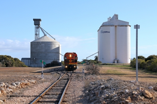 130704 0440
Kyancutta, located at the 203.1 km and opened in March 1916, overview of yard with Ascom silo complex on the left with new siding which was installed in 1970 and the eight cell concrete SACBH silo complex on the right as the second driver returns to the locomotive to depart south bound for Port Lincoln. 4th July 2013.
Keywords: 1200-class;1204;Clyde-Engineering-Granville-NSW;EMD;G12C;65-428;A-class;A1514;