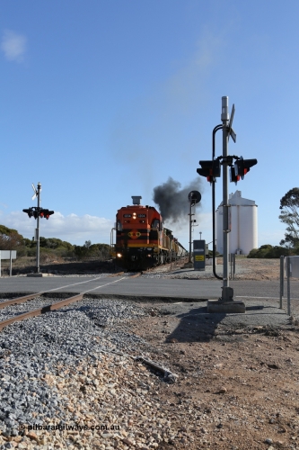 130704 0442
Kyancutta, the south bound loaded grain train gets away from attaching a further fourteen loads here as it is about to cross the Eyre Highway grade crossing with F Type flashing lights. 4th July 2013.
Keywords: 1200-class;1204;Clyde-Engineering-Granville-NSW;EMD;G12C;65-428;A-class;A1514;