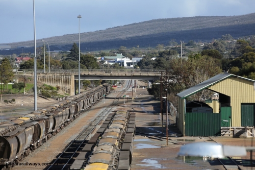 130706 0673
Port Lincoln, looking in the down direction from the London Street overbridge at the yard environs with the AN Freight Shed now museum on the right. The sign next to the point indicator states the Depot is Unattended. 6th of July 2013.
