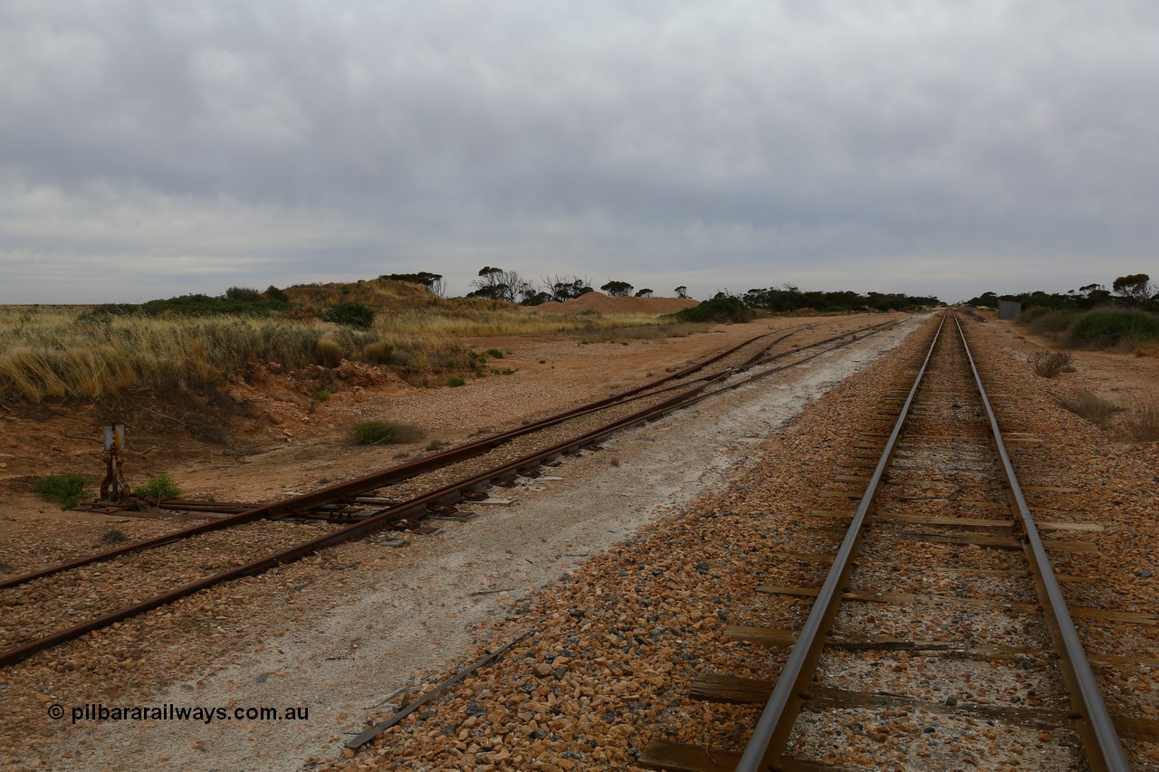 161109 1887
Moule, located at the 445.6 km, and opened on the 13th February 1966, the siding location once sported ballast loading bins during construction, looking towards Thevenard. Ballast is stockpiled on the left, opposite the station shed on the right.
