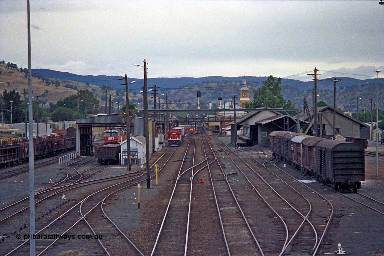 100-01
Albury station yard overview looking south, from Wilson Street footbridge, loco shed with 81 class, 48 class yard shunter, 81 class beside station with north bound goods train, goods sheds at right with louvre vans. [url=https://goo.gl/maps/nngpTA37VQekQpCt7]Geodata[/url].
Keywords: 81-class;48-class;