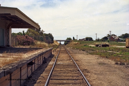 100-24
Rutherglen station yard overview, station building and platform, broad gauge track view looking towards Wahgunyah, High Street over bridge in distance, up home semaphore signal below, edge of yellow GY type four wheel open waggon at right.
Keywords: GY-type;fixed-wheel-waggon;