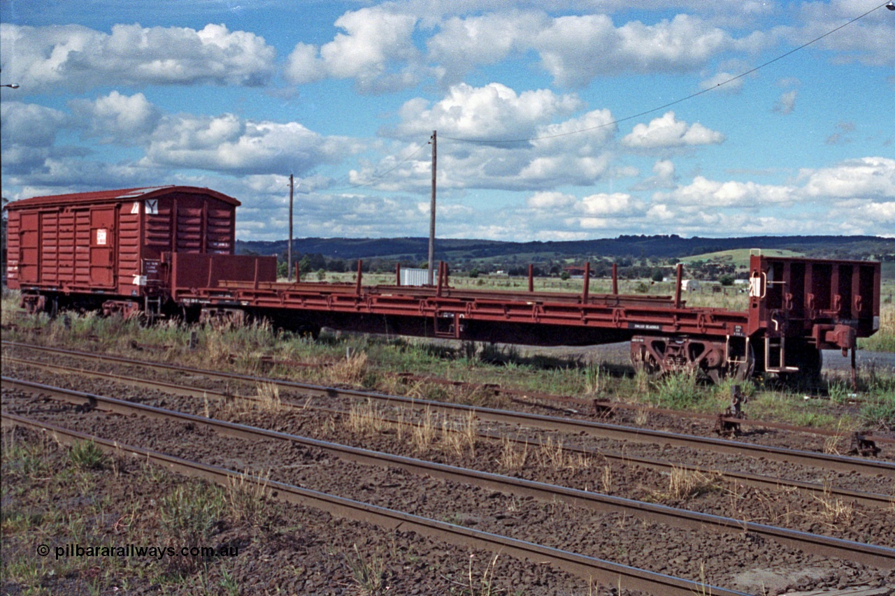 104-24
Wallan, V/Line broad gauge VFLX type bogie bulk end flat waggon VFLX?? loaded with rail and a VLBY type bogie louvre van on No.3 Rd. The VFLX is fitted with a lashing rail, possibly ex SFX / VFMX panelboard flat waggon.
Keywords: VFLX-type;VLBY-type;Victorian-Railways-Newport-WS;FLX-type;