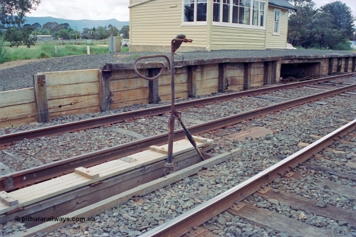 104-11
Buangor station building view, detail shot of automatic staff exchanger set up, looking east, signal wires running along platform face.
