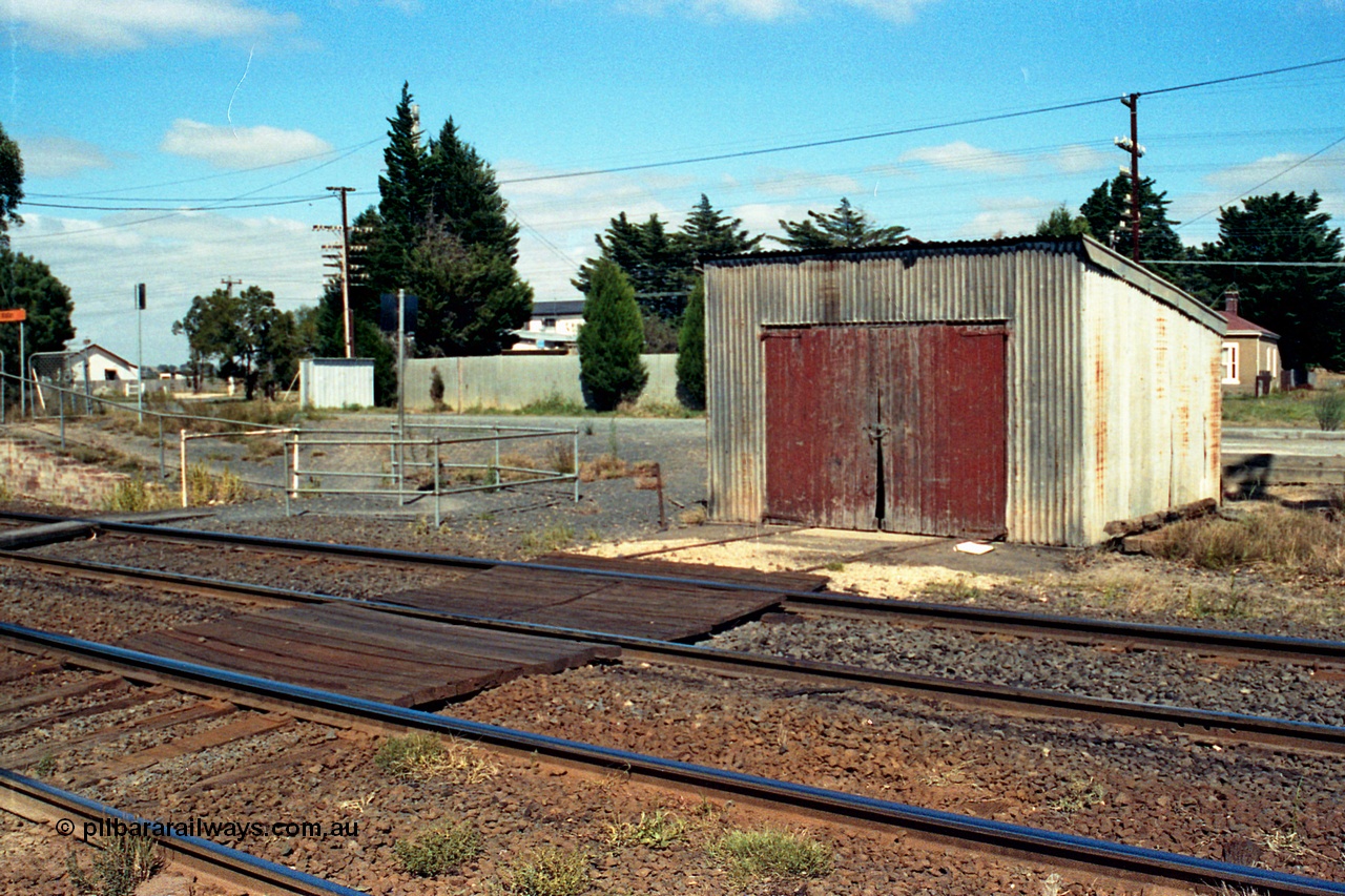 105-13
Wallan, gangers trolley shed, front 3/4 view, shows track timber work, crib crossing.
