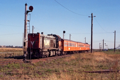 105-02
Wallan, V/Line broad gauge P class P 17 Clyde Engineering EMD model G18HBR serial 84-1216 rebuilt from T 327 Clyde Engineering EMD model G8B serial 56-78 with a Victorian Railways 'Tea Cup' liveried H set with V/Line decals, down passenger train 8319, disc signal post 11 for removed Sidings B, worked out from this shot that on this angle, a P class and H set won't fit between the disc post and light post!!
Keywords: P-class;P17;Clyde-Engineering-Somerton-Victoria;EMD;G18HBR;84-1216;rebuild;