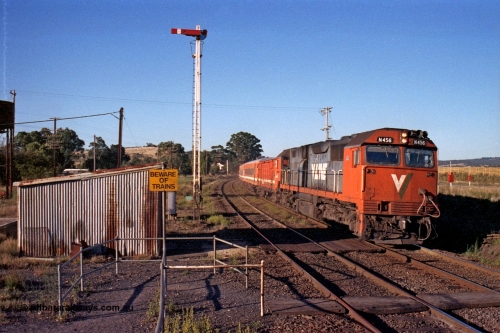 105-08
Wallan, broad gauge V/Line N class loco N 456 'City of Colac' with serial 85-1224 a Clyde Engineering Somerton Victoria built EMD model JT22HC-2 arrives with an up Albury passenger train, gangers trolley shed, crib crossing and semaphore signal post 12 for down movements.
Keywords: N-class;N456;Clyde-Engineering-Somerton-Victoria;EMD;JT22HC-2;85-1224;