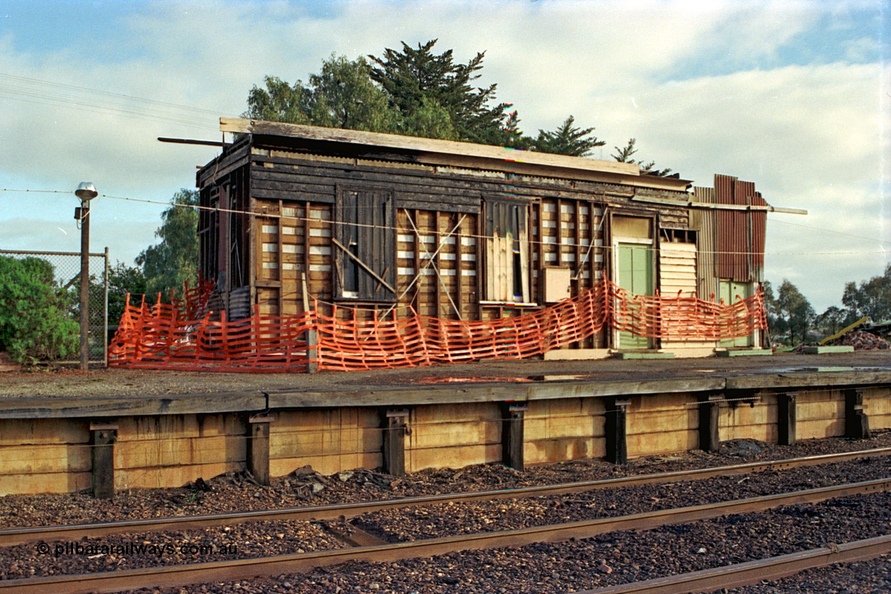 106-29
Nagambie station building, booking office end, has been on fire, signal levers just visible through bunting on platform, in the process of being demolished.
