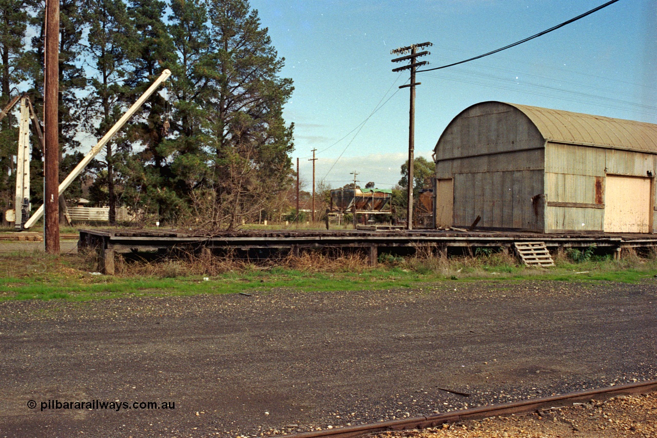 108-26
Tatura, yard curved roof goods shed and platform, derrick crane behind.
