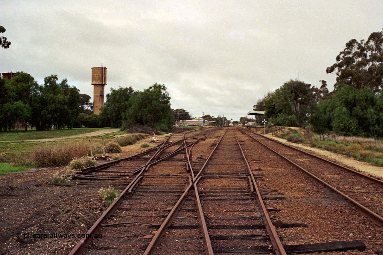 108-35
Kyabram station yard overview north end, looking south, tracks removed, station building at right.
