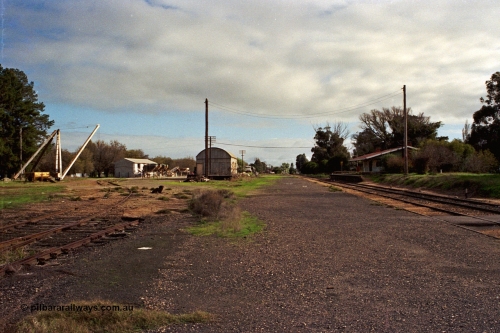 108-21
Tatura station yard overview, derrick crane, super phosphate shed, goods shed and station building, looking north.
