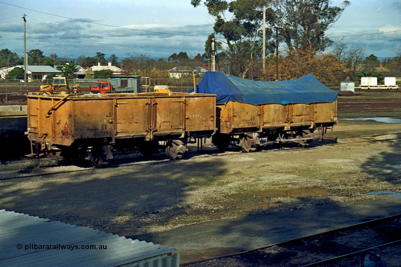 110-14
Benalla yard, GY type four wheel waggons GY 16209 and GY 5514 in super phosphate traffic. GY 5514 built new by AE Goodwin in February 1954, while GY 16209 was built in 1949 by Victorian Railways Newport Workshops as an HY type, in September 1964 recoded to GY.
Keywords: GY-type;GY16209;GY5514;fixed-wheel-waggon;Victorian-Railways-Newport-WS;HY-type;AE-Goodwin;