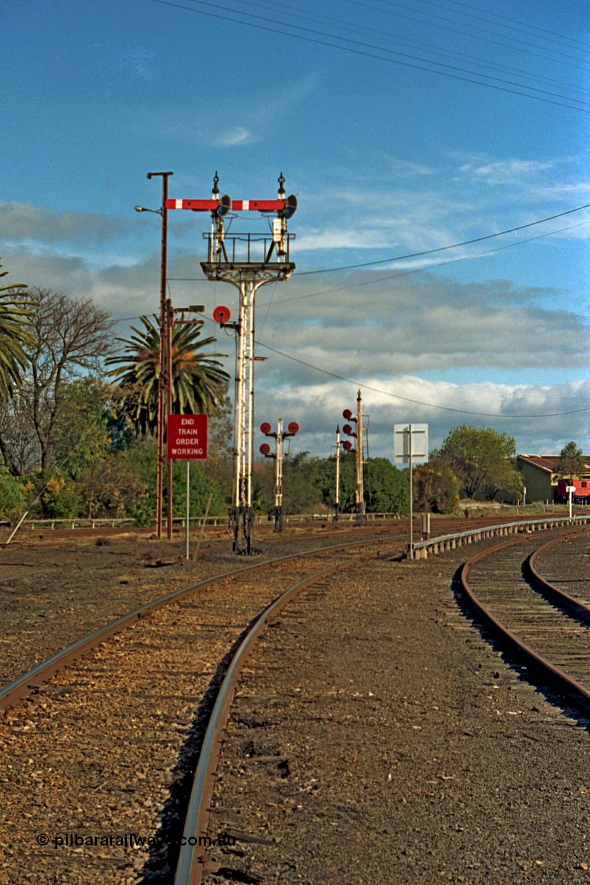 110-15
Benalla, up home semaphore signal post 29B Yarrawonga line into Benalla yard and End of Train Order Working sign, triple disc signal posts 29 and 32 are in the background, taken on the 14th July 1991. Only a couple of weeks later and these signals would be reduced in number greatly as Benalla yard was heavily rationalised, all in the name of progress!
