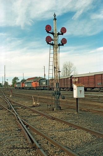 110-08
Benalla yard view, quad disc signal post 12 looking north, broad gauge V/Line S class S 302 'Edward Henty' Clyde Engineering EMD model A7 serial 57-166, B class B 64 Clyde Engineering EMD model ML2 serial ML2-5 and V/Line T class loco T 403 with serial 67-498 a Clyde Engineering Granville NSW built EMD model G18B, stabled down Wodonga goods train 9303, point levers, telephone cabinet for talking to signal box.
Keywords: S-class;S302;Clyde-Engineering-Granville-NSW;EMD;A7;57-166;bulldog;B-class;B64;ML2;ML2-5;T-class;T403;G18B;67-498;