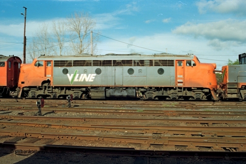 110-10
Benalla yard view, broad gauge V/Line B class B 64 Clyde Engineering EMD model ML2 serial ML2-5, side view, stabled down Wodonga goods train 9303, ground dwarf disc signals.
Keywords: B-class;B64;Clyde-Engineering-Granville-NSW;EMD;ML2;ML2-5;bulldog;