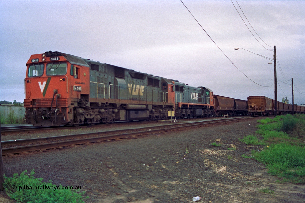 111-02
North Geelong grain arrivals yard, V/Line broad gauge locos N class N 461 'City of Ararat' Clyde Engineering EMD model JT22HC-2 serial 86-1190 and X class X 47 Clyde Engineering EMD model G26C serial 75-794 with a loaded grain rake pump up the air, another loaded grain rake on the right, off focus.
Keywords: N-class;N461;Clyde-Engineering-Somerton-Victoria;EMD;JT22HC-2;86-1190;