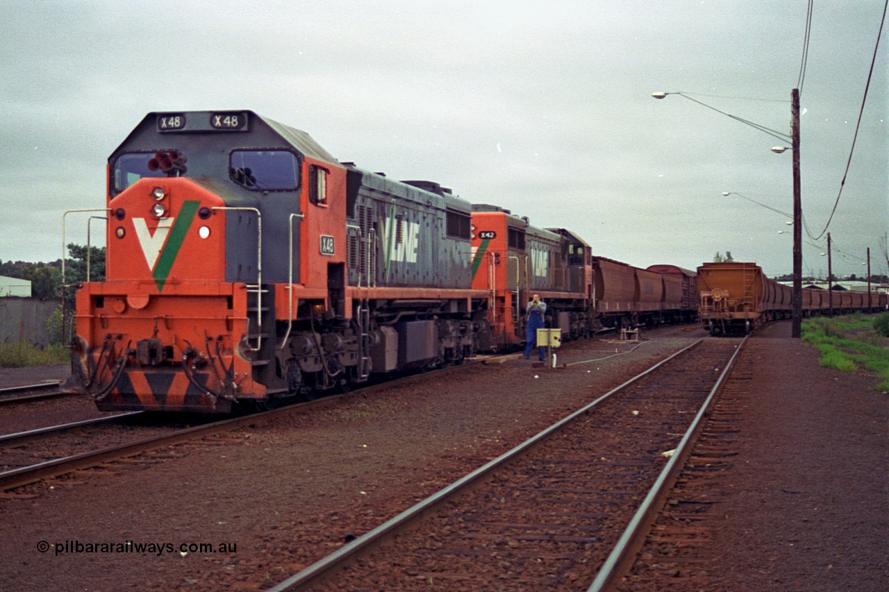 111-11
North Geelong grain arrivals yard, V/Line broad gauge loco X class X 48 Clyde Engineering EMD model G26C serial 75-795 shunts backs onto older sister X 42 serial 70-705 with the up Mt Gambier goods train 9192, loaded grain rake on the right.
Keywords: X-class;X48;Clyde-Engineering-Rosewater-SA;EMD;G26C;75-795;